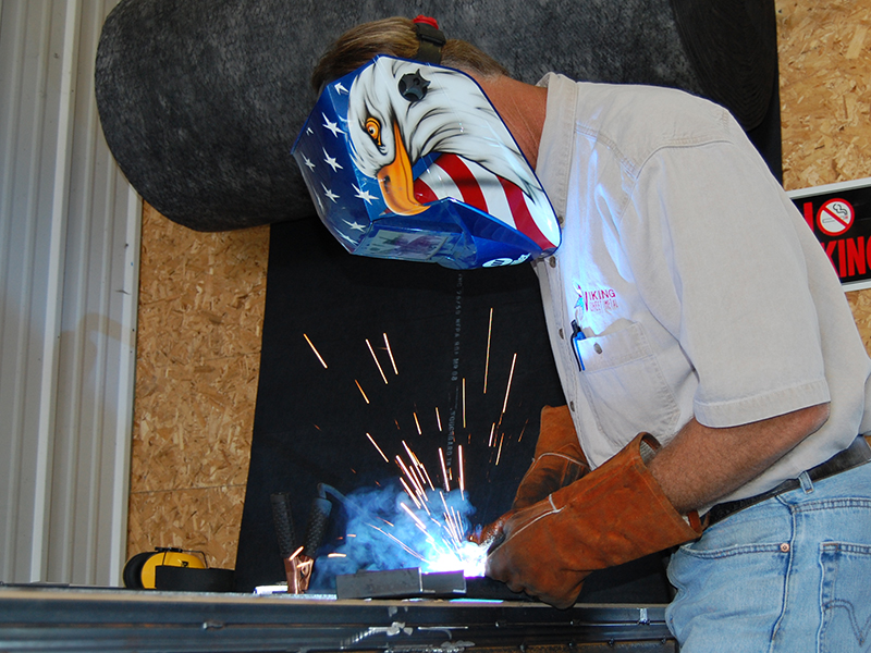 Viking Mechanical employee checking a residential air-conditioning unit.